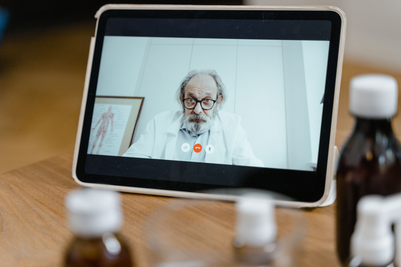 A doctor on a video call on a tablet.