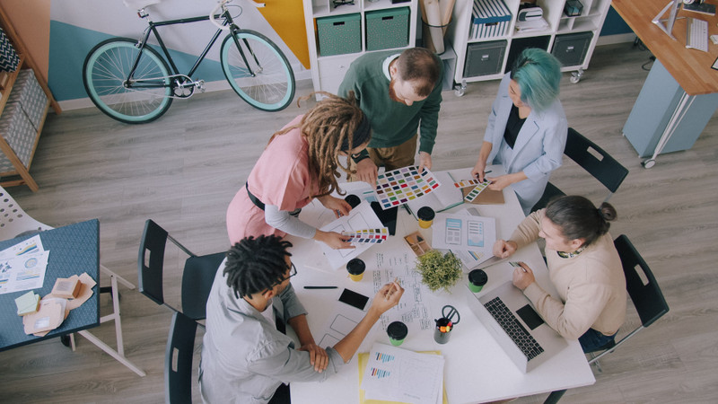 The team planning around a table with colour swatches.
