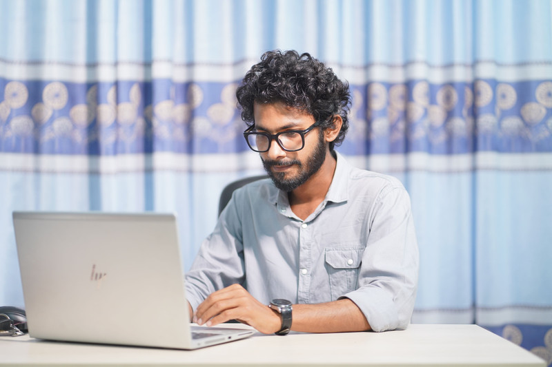 An engineer at work in a bright room.